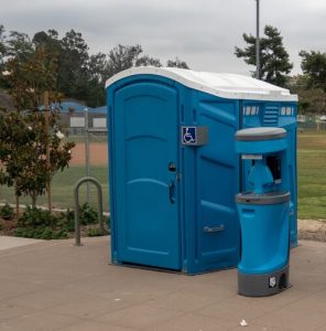 wheelchair accessible porta potty with a hand washing area